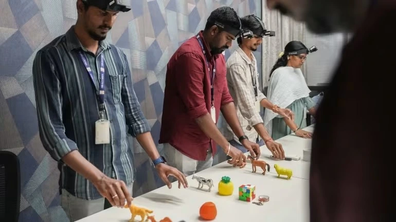 Researchers wearing head-mounted cameras to collect first-person view data, training an AI model by interacting with toy animals